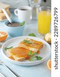 Small photo of Sandwiches with marmalade, orange juice and coffee ready for breakfast