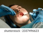 Small photo of Dental surgeon performs conduction anesthesia with lidocaine using a carpool syringe female patient's mouth before removing wisdom tooth, the maxillary third molar. Real procedure. Close up image