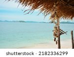 shell necklace on a thatched bamboo hut on the beach of a tropical island, beautiful view of the beach. copy space