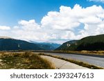 Landscape with mountains, green hills and cloudy sky, Transalpina road, Romania.