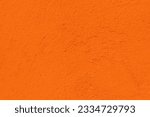 Orange color textured concrete wall with space for text