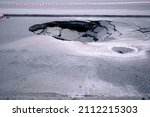 Small photo of A large pit in the asphalt due to a pipeline accident. A hole in the ground in the middle of the road. Asphalt that has collapsed underground