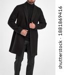 Small photo of man wears black overcoat. isolated studio shot of stylish man in dark full length greatcoat