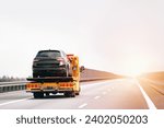 Small photo of A tow truck with a broken car on a road. Tow truck transporting a car on the highway. Car service transportation concept. Roadside Rescue.