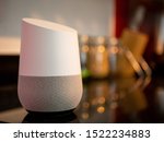 Smart home assistant speaker on kitchen worktop in home setting