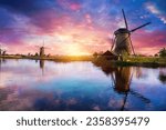 Small photo of Windmill in Holland Michigan - An authentic wooden windmill from the Netherlands rises behind a field of tulips in Holland Michigan at Springtime. High quality photo