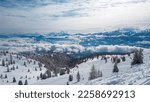 Small photo of A snow capped slopes of Gerlitzen in Austria. There are endless snow capped mountain chains. Few tress in the middle of white slopes. Winter ski resort. Skiing remedy.