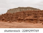 Small photo of Scenic view on unique eroded Hoodoo Rock Formations at Goblin Valley State Park in Utah, USA, America. Sandstone rocks called goblins which are mushroom-shaped rock pinnacles. Wild horse mesa in back