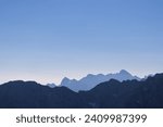 Small photo of Silhouette of mountain peaks of wild Julian Alps seen on scenic hiking trail to majestic summit Mangart, Friuli Venezia Giulia, border Italy Slovenia, Europe. Hiking wanderlust in alpine wilderness