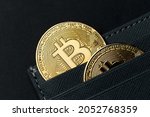The gold coin of bitcoin are invested in a wallet. Bitcoin purchase concept. Bitcoin and wallet. Bitcoin Conservation. Cryptocurrency. Close-up. Copy space