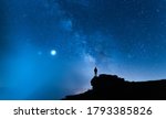 Small photo of Person contemplating the vastness of the universe. Small silhouette of a man under the Milky Way and the magical starry sky. Concept of human smallness.