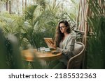Beauty woman using tablet with pencil in cafe, paining illustrations, dreamer, drinking coffee, using smartphone, freelancer moods, laptop, hipster, art, nft collection, glasses, Bali, concept