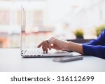 Close-up image of woman hands typing and writing massages on laptop,working on cafe.Overhead of essentials for modern young person.sensual woman reading and working,Urban