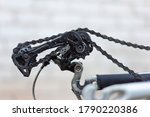 the rear derailleur of the bike is broken, no wheel. close-up, on a white background