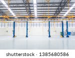 The electric lift for cars in the service put on the epoxy floor in new car factory service , Car repair service center blurred  background for industry 