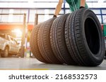 Small photo of Male car mechanic change tire In the process of bringing 4 new tires in the tire shop to replace the wheels of a motorcycle at a service center or auto repair shop for the automobile industry