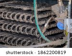 Dirty refrigerator condenser cooling coils covered in dust and pet hair. Concept of household chores, appliance repair, maintenance and service.