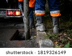 Small photo of Cleaning storm drains from debris, clogged drainage systems are cleaned with a pump and water