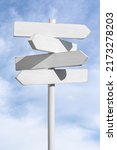 Small photo of Blank white signpost on blue sky background. Choose the correct way concept. Mock up, template