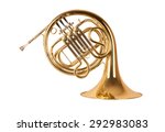 Golden french horn in hard light isolated on white background