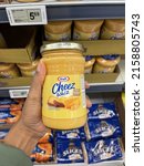 Small photo of Edmonton, Canada - May 13, 2022: A person holding a jar of Kraft Cheez Whiz