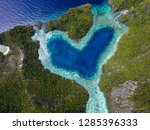 Aerial top view of turquoise lagoon in heart shape 