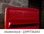 A pillarbox red postbox owned by the post office for posting letters
