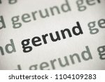 Small photo of word gerund printed on white paper macro