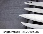 The Blades of knives concept. Sharp steel blades of knives on a dark background. Sharp knives collection.