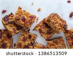 Organic vegan flapjack made with dates, cranberries and apricots with no animal products for super healthy diet on a white marble base