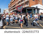 Small photo of Brighton, East Sussex, United Kingdom - August 6th 2022: Marchers carrying a Don't Hate Gyrate placard at the Brighton and Hove Community Pride Parade 2022 event in the summer sunshine