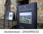 Small photo of Battle, East Sussex, United Kingdom - January 28th 2024: The 1066 Battle of Hastings sign from English Heritage outside the entrance to Battle Abbey Gatehouse