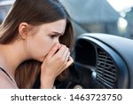 the driver held his nose from the bad smell , air conditioner heating, the concept of faulty air conditioners, bad smell and car, refilling of refrigerant in the air conditioner