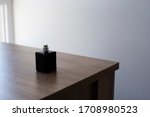 Small photo of Bottle of perfume on wooden table. Dicey form of glass with silver details on top. Perfume workshop banner idea.