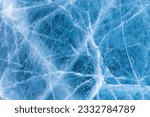 Small photo of Beautiful winter natural blue ice texture of surface of frozen Baikal Lake in cold day. Nature abstract pattern of white cracks. Winter seasonal background, mock up, flat lay, blank, closeup, top view