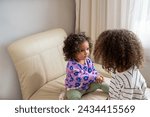 Small photo of Two siblings are thoughtfully looking at each other, A picture for national siblings day and sisterhood, used for friendships between sisters and siblings . High quality photo