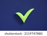 Small photo of Checkmark sign on blue background. Concept of well done, confirmation or approval, positive answer.