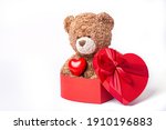 teddy bear hold heart and sitting in a heart shaped box isolated on a white background, Valentines day 
