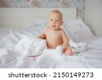 A Baby Boy In A Diaper Is...
