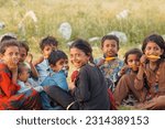 Small photo of Group of poor Pakistani children holding popsicle, setting near camp in Punjab, Pakistan..... Dated 06 June, 2023
