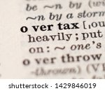 Small photo of Dictionary definition of word overtax, selective focus.