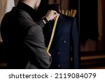 Small photo of tailor takes measurements from a business suit. handmade work. tailoring workshop