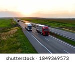 Small photo of Semi-trailer truck DAF and IVECO driving on highway. Truck on asphalt road overtakes another truck on sunset background. Out of focus, possible granularity. RUSSIA, MOSCOW - SEPT 12, 2020