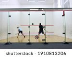 Squash player in action reaching on squash court. Squash Players on Tournament. Sports equipment and sportswear for playing squash.  Soft focus