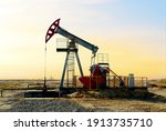 Small photo of Crude oil pump jack at oilfield on sunset backround. Fossil crude output and fuels oil production. Oil drill rig and drilling derrick. Global crude oil Prices, energy, petroleum demand