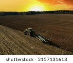 Tractor With Plow On Field...