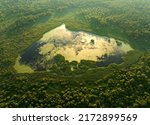 Small photo of Lake in shape of a heart in forest. Freshwater Lakes. Water supply problems and water deficit, ecology and environmental. Morass and wetlands, aerial view. Mire Conservation. Bog, fen, mire landscape.