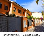Suburb house building Exterior. Villa at seaside. Fence at house in Valencia. Suburv luxury apartments. Fence and facade of the house near beach and sea. House at coast. Penthouse apartments village.