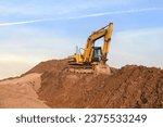 Small photo of Excavator on earthmoving. Open pit mining. Backhoe dig ground in quarry. Heavy construction equipment on excavation on construction site. Excavator on groundwork foundation. Excavation contractors
