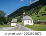 Small photo of A church divided in two by a road. The location is in Trentino, Italy.